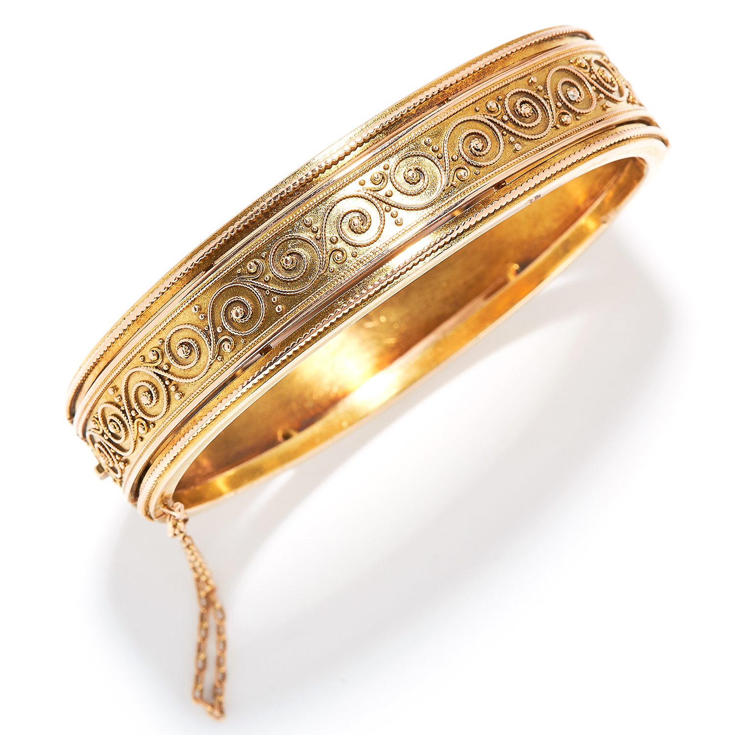 GOLD BANGLE, CARL BACHER in yellow gold, Etruscan revival manner with scrolling wirework designs,