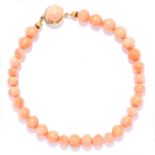 CORAL BEAD BRACELET in 18ct yellow gold, comprising of a single row of coral beads, stamped 750,