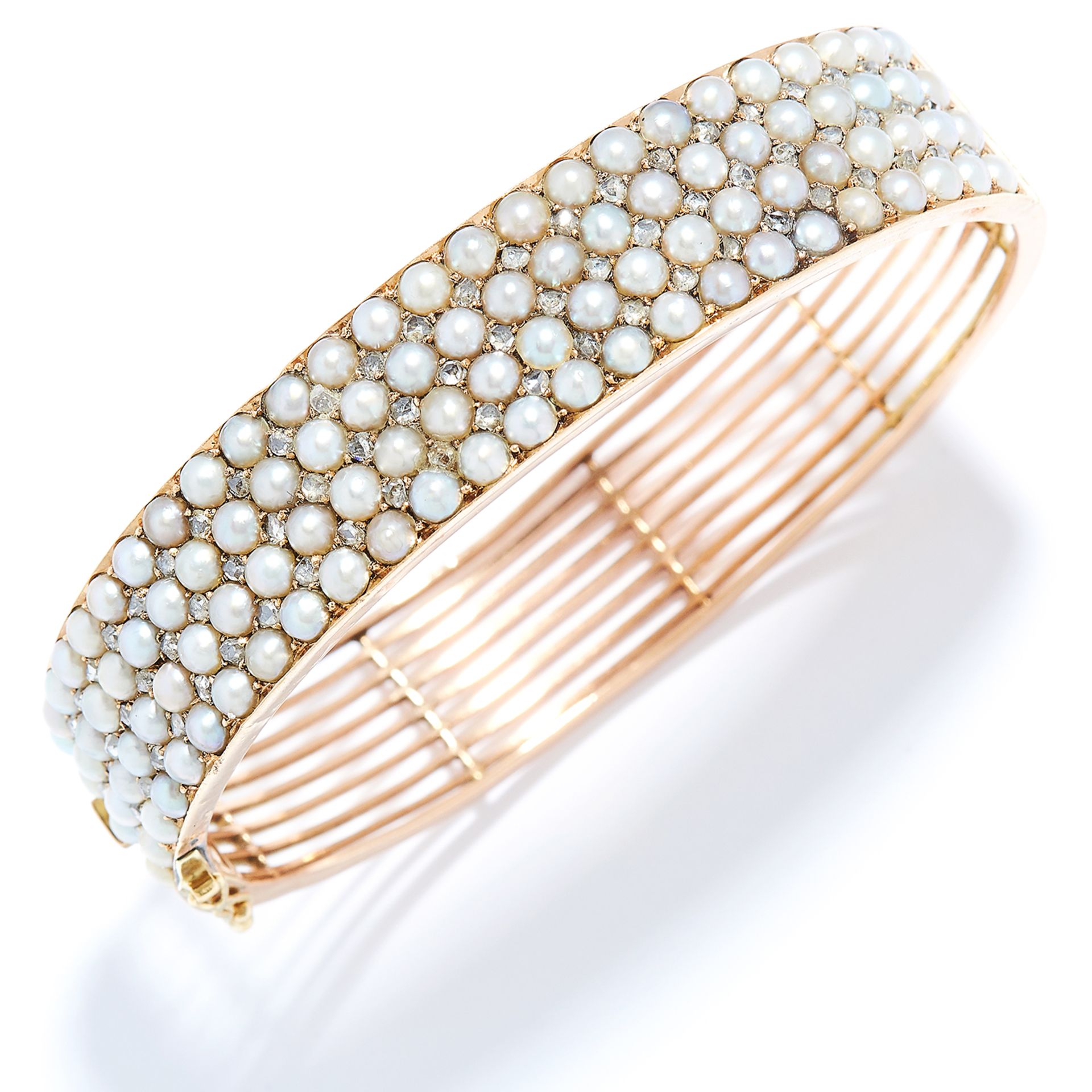 ANTIQUE SEED PEARL AND DIAMOND BANGLE in 15ct yellow gold, set with four rows of seed pearls