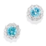 BLUE ZIRCON AND DIAMOND STUD EARRINGS in platinum or white gold, each set with a round cut blue