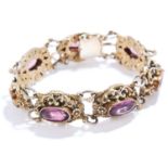 ANTIQUE AMETHYST BRACELET in sterling silver, set with seven oval cut amethyst links in foliate