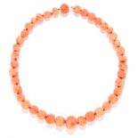 CARVED CORAL BEAD NECKLACE in yellow gold, comprising of a single strand of carved coral beads,