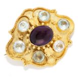AMETHYST AND AQUAMARINE BROOCH in high carat yellow gold, set with a cabochon amethyst in a border