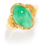 CHINESE JADEITE JADE RING in high carat yellow gold, the oval jade cabochon between foliate