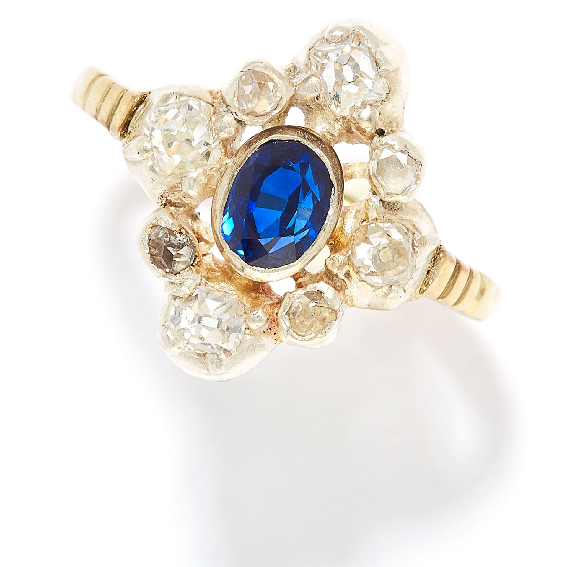 SAPPHIRE AND DIAMOND RING in yellow gold, set with an oval cut sapphire in a cluster of old cut