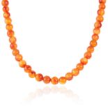 A CARNELIAN BEAD NECKLACE in silver, comprising of fifty-seven polished carnelian beads, stamped