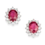 RUBY AND DIAMOND CLUSTER EARRINGS in 18ct white gold, each set with an oval cut ruby in a cluster of