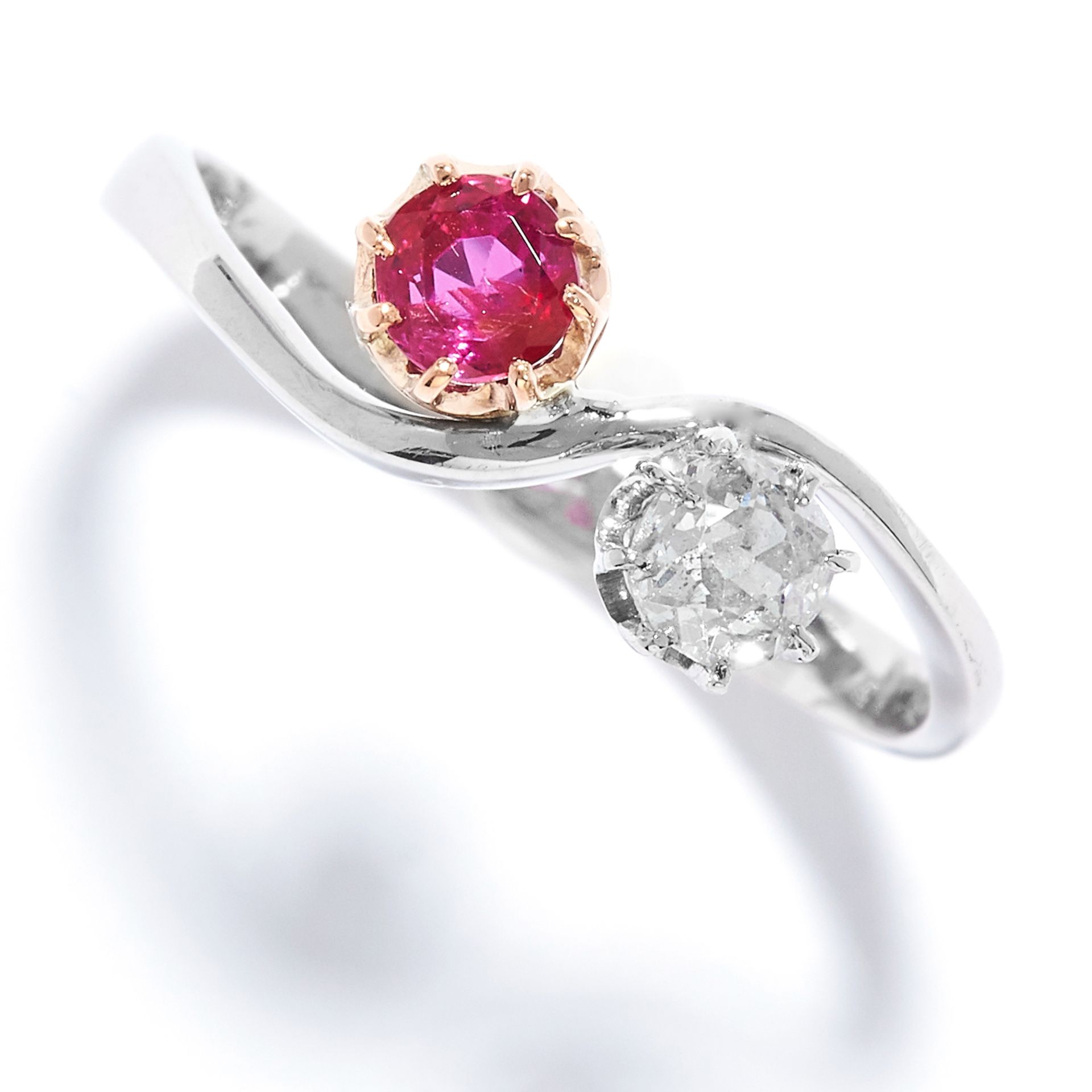 RUBY AND DIAMOND TOI ET MOI RING in platinum, set with a round cut ruby and diamond, stamped