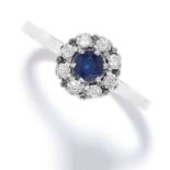 SAPPHIRE AND DIAMOND CLUSTER RING in white gold, set with a round cut sapphire in a cluster of round