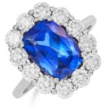 TANZANITE AND DIAMOND CLUSTER RING in 18ct white gold, set with an oval cushion cut tanzanite in a
