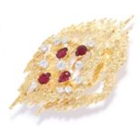 RUBY AND DIAMOND BROOCH / PENDANT, CIRCA 1976 in Modernist design, jewelled with eleven round cut