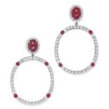 RUBY AND DIAMOND EARRINGS each comprising of a cabochon ruby in a border of round cut diamonds,