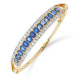 ANTIQUE SAPPHIRE AND DIAMOND BANGLE set with a half band of cushion cut sapphires between rows of