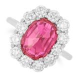 RUBY AND DIAMOND CLUSTER RING set with an oval faceted ruby in a cluster of round cut diamonds, size