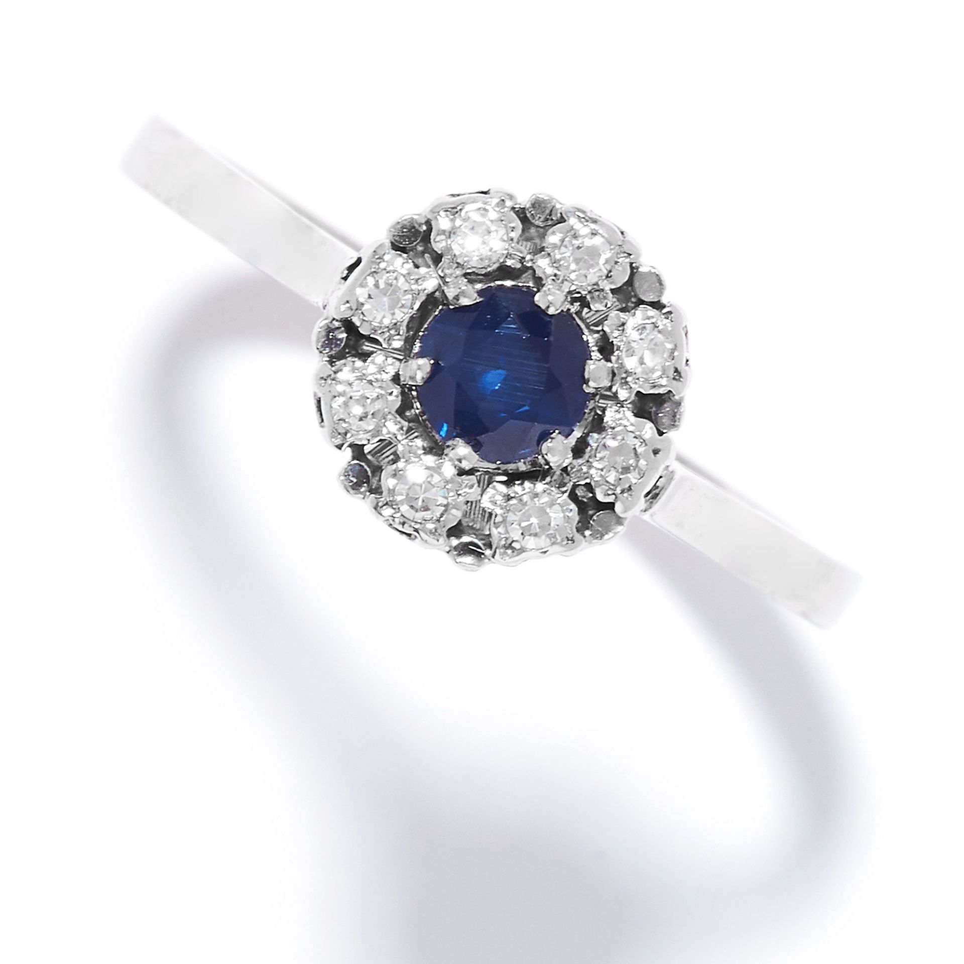 SAPPHIRE AND DIAMOND CLUSTER RING set with a round cut sapphire in a cluster of round cut