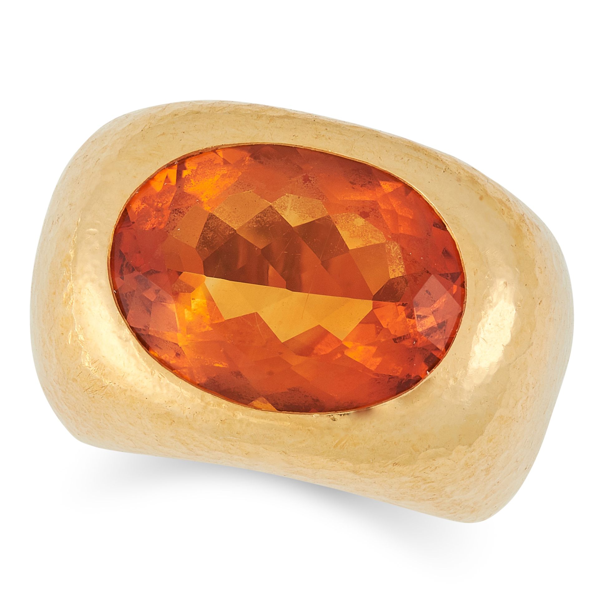 A CITRINE RING, CIRCA 1970 set with an oval cut citrine in a hammered gold mount, stamped 22K,