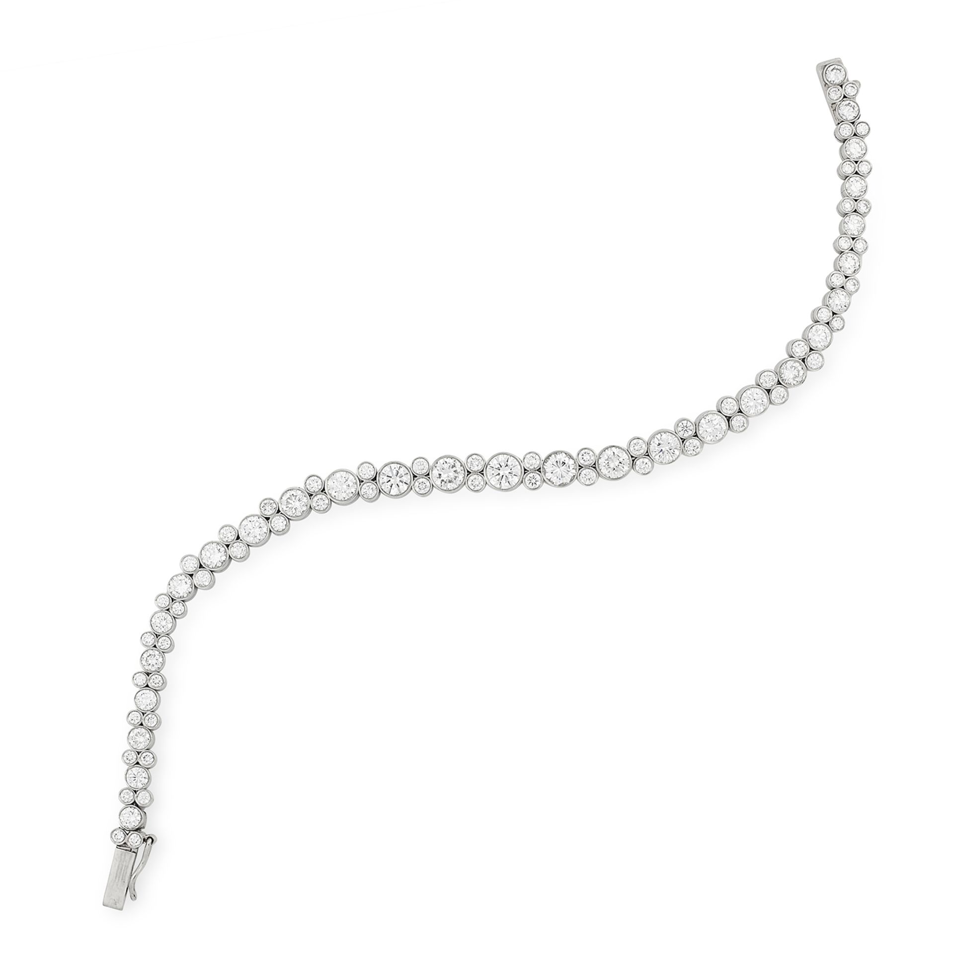 A DIAMOND LINE BRACELET comprising of a single row of graduated round cut diamonds accented by pairs