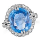 A 9.63 CARATS SAPPHIRE AND DIAMOND CLUSTER RING set with a central oval cut sapphire of 9.63