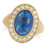 A SAPPHIRE AND DIAMOND CLUSTER RING set with a cabochon sapphire of 8.61 carats in a border of round