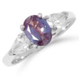 AN ALEXANDRITE AND DIAMOND THREE STONE RING set with a central oval cut alexandrite between two pear