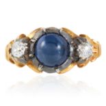 A SAPPHIRE AND DIAMOND RING set with a cabochon sapphire of approximately 2.60 carats between two