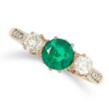 AN EMERALD AND DIAMOND THREE STONE RING set with a central round cut emerald between two round cut