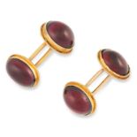 ANTIQUE GARNET CUFFLINKS set with cabochon garnets in a gold border, 2cm, 6.3g.