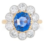 A CEYLON NO HEAT SAPPHIRE AND DIAMOND CLUSTER RING set with a central oval cut sapphire of 3.65