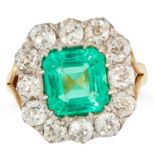 A COLOMBIAN EMERALD AND DIAMOND CLUSTER RING set with an emerald cut emerald of 2.45 carats in a