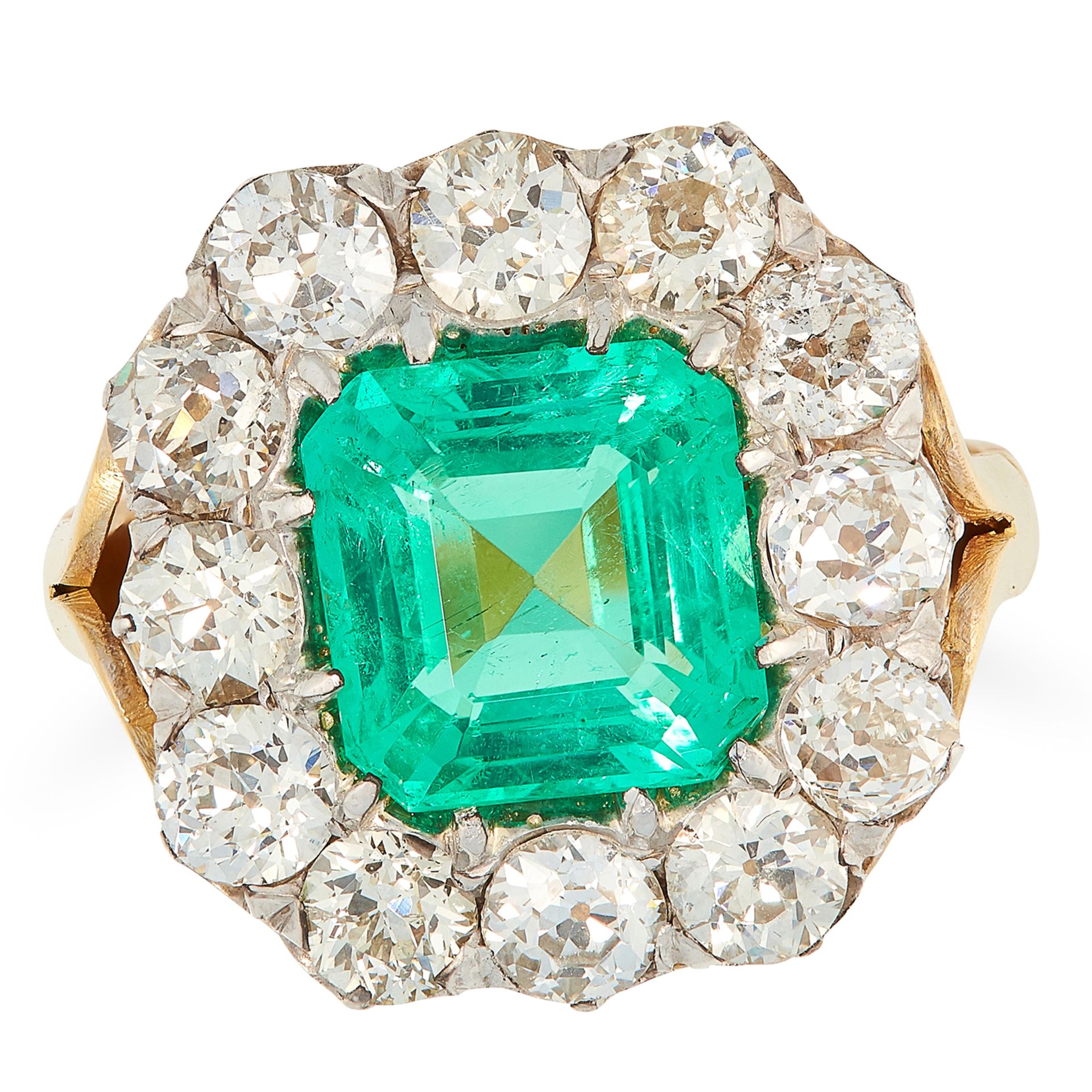 A COLOMBIAN EMERALD AND DIAMOND CLUSTER RING set with an emerald cut emerald of 2.45 carats in a