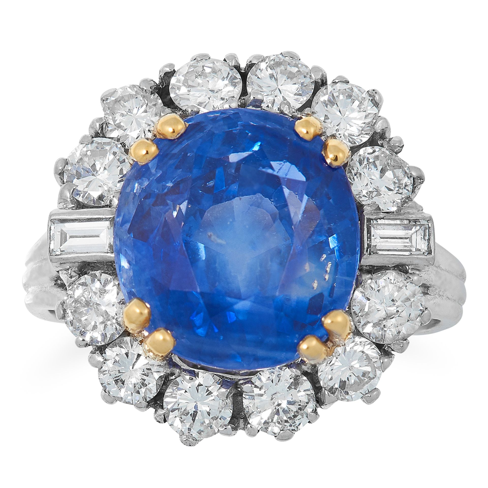 A SAPPHIRE AND DIAMOND CLUSTER RING set with a cushion cut sapphire of 10.87 carats in a cluster