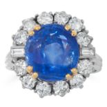 A SAPPHIRE AND DIAMOND CLUSTER RING set with a cushion cut sapphire of 10.87 carats in a cluster