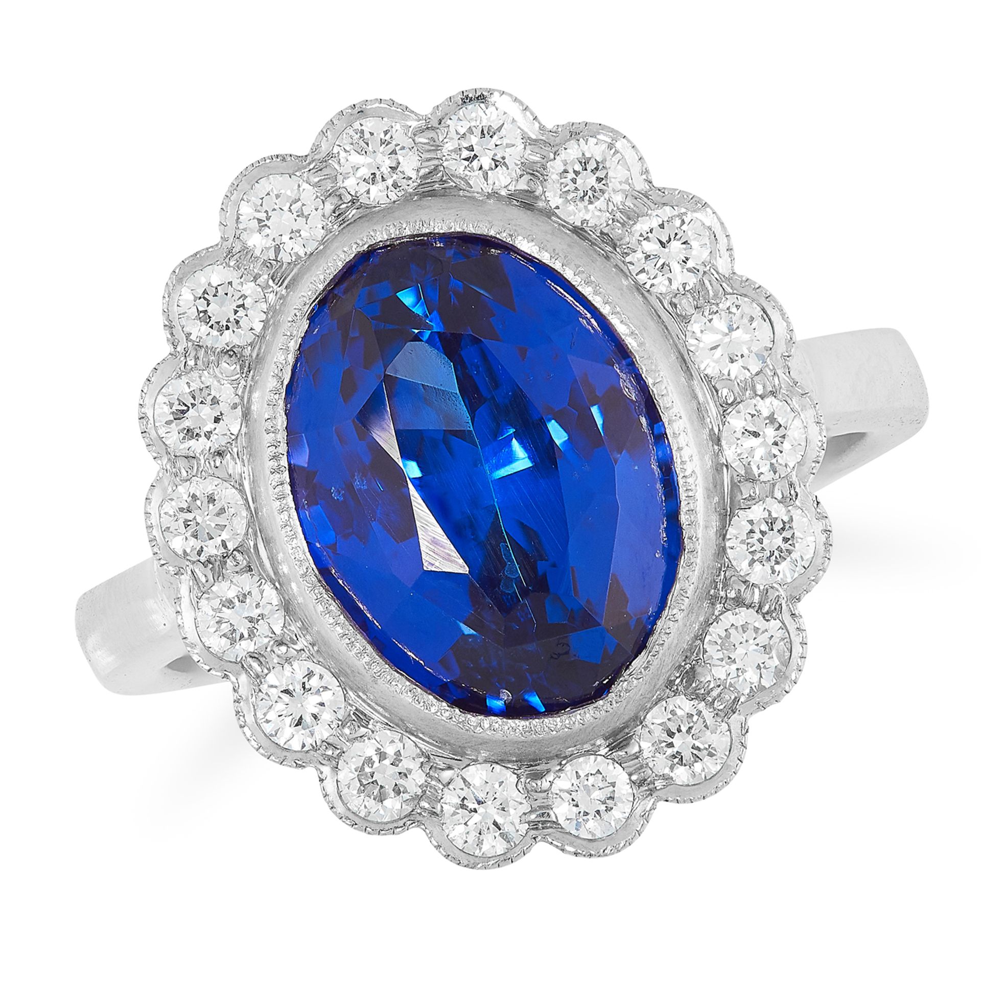 A TANZANITE AND DIAMOND CLUSTER RING set with an oval cut tanzanite of 4.92 carats in a cluster of