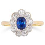 A SAPPHIRE AND DIAMOND CLUSTER RING set with an oval cut sapphire in a cluster of round cut