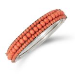CORAL BANGLE set with three rows of coral beads, 6cm inner diameter, 23.7g.