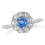 SAPPHIRE AND DIAMOND CLUSTER RING set with a round cut sapphire in a border of round cut diamonds,