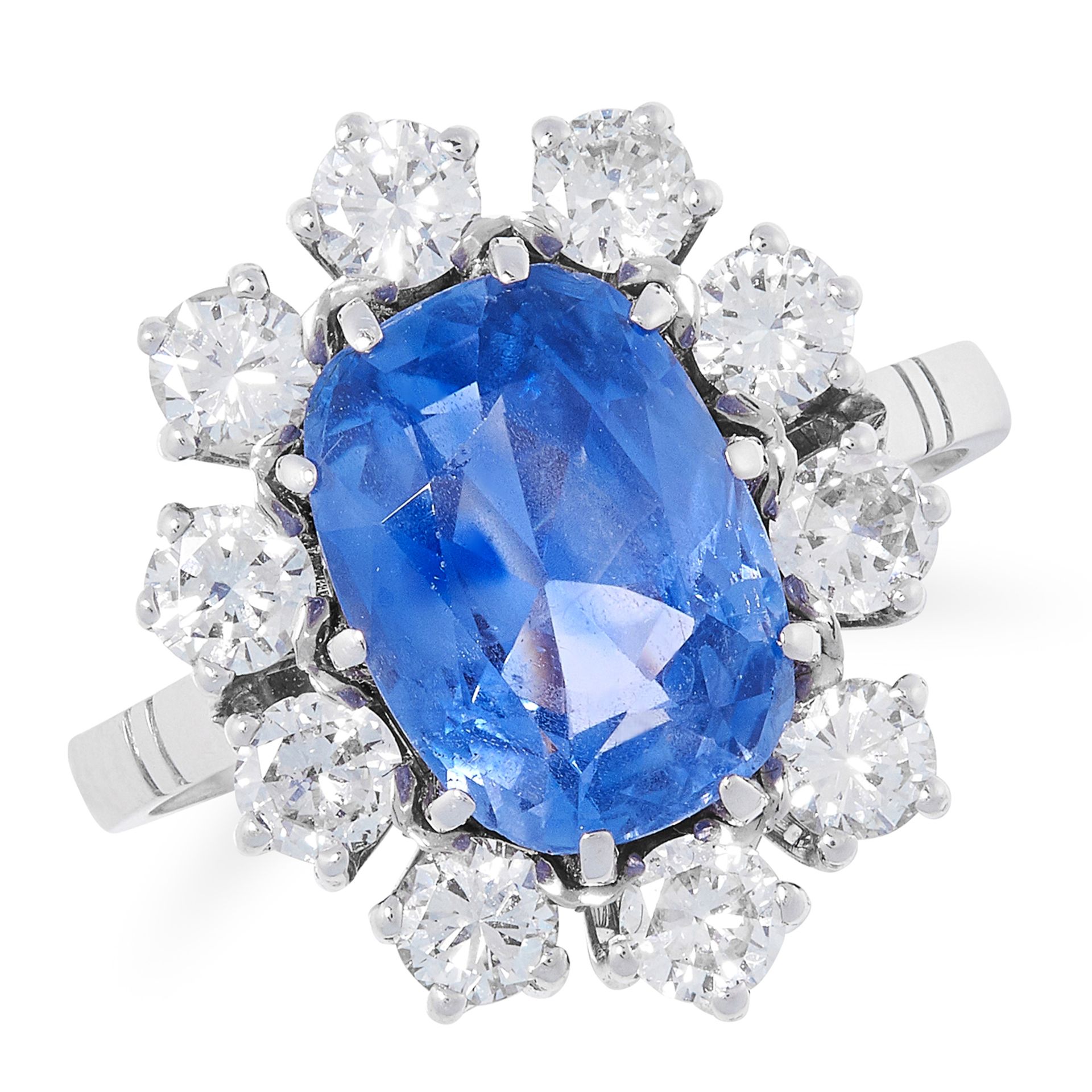 4.15 CARAT CEYLON NO HEAT SAPPHIRE AND DIAMOND CLUSTER RING comprising of an oval cut sapphire of