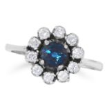 SAPPHIRE AND DIAMOND CLUSTER RING set with a round cut sapphire in a border of round cut diamonds,