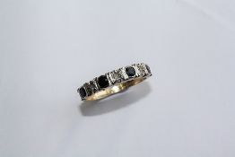 A SAPPHIRE, DIAMOND AND 9CT YELLOW GOLD RING