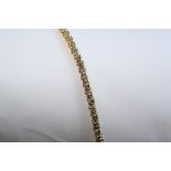 AN 18CT YELLOW GOLD AND DIAMOND LINE BRACELET