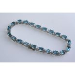 AN 18CT WHITE GOLD AND BLUE TOPAZ BRACELET