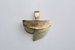 AN UNUSUAL SHARKS TOOTH PENDANT