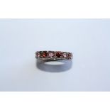 A TOURMALINE AND 9CT WHITE GOLD ETERNITY RING