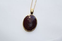 AN 18CT YELLOW GOLD AND RUBY PENDANT