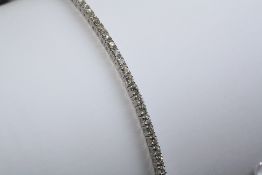 AN 18CT WHITE GOLD AND DIAMOND LINE BRACELET