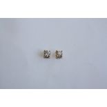 A PAIR OF 18CT YELLOW GOLD AND DIAMOND STUD EARRINGS