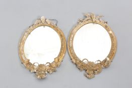 A PAIR OF VICTORIAN GILT GESSO OVAL MIRRORS
