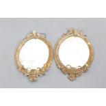 A PAIR OF VICTORIAN GILT GESSO OVAL MIRRORS