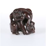 A JAPANESE WOODEN NETSUKE OF MONKEYS