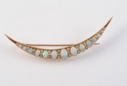 A LATE 19TH CENTURY OPAL AND DIAMOND SET CRESCENT BROOCH
